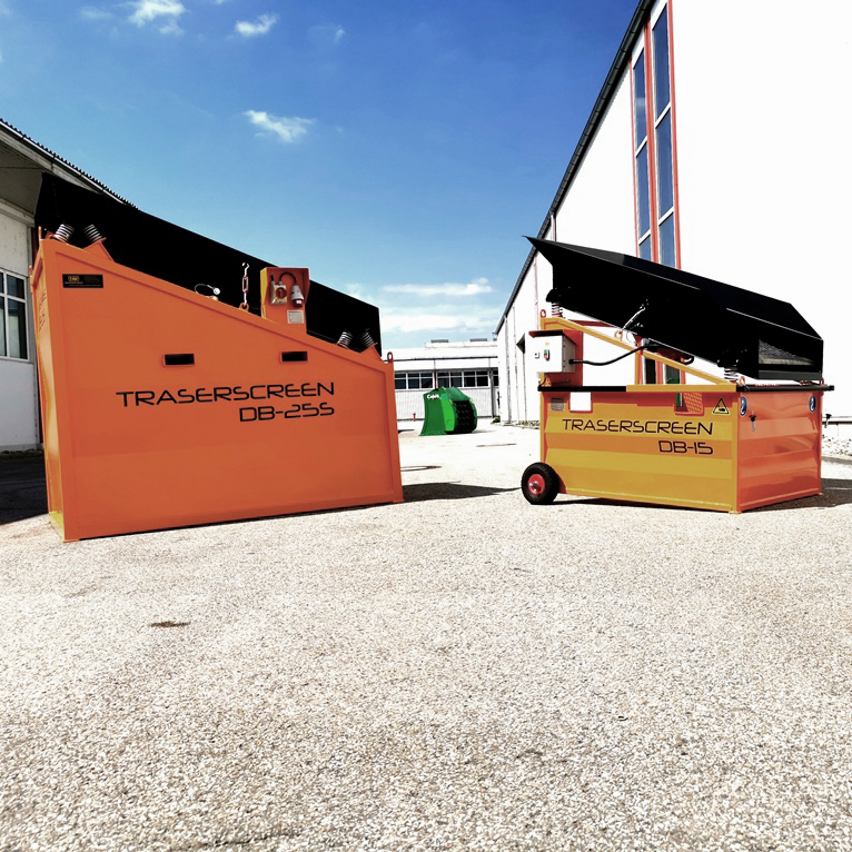 Zwei orange Traserscreen-Siebmaschinen, darunter DB-25S und DB-15, stehen im Hof zwischen Gebäuden unter blauem Himmel.
