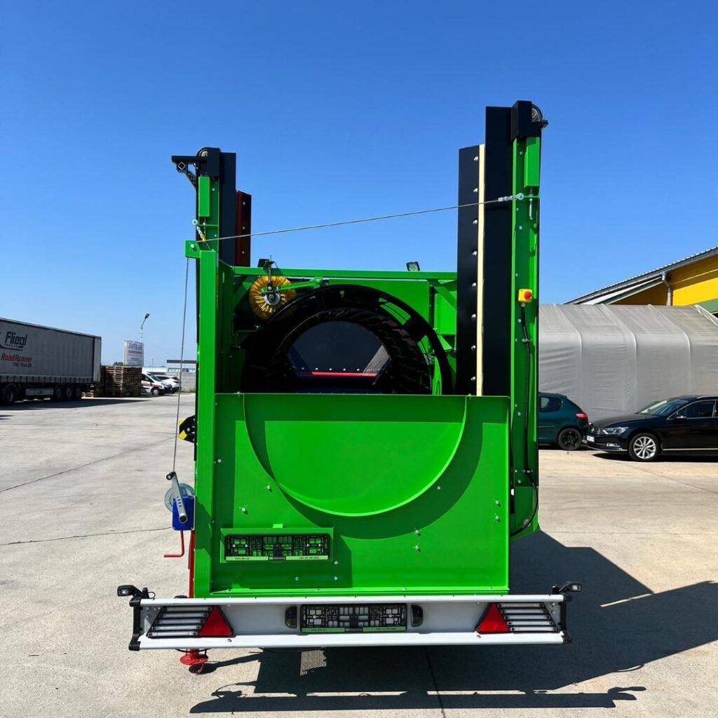 Grüne Recyclingmaschine DB-70-2 mit hoher Stahlkonstruktion, schwarzem Rundgehäuse und rotem Warnlicht steht auf einem Hof unter blauem Himmel.