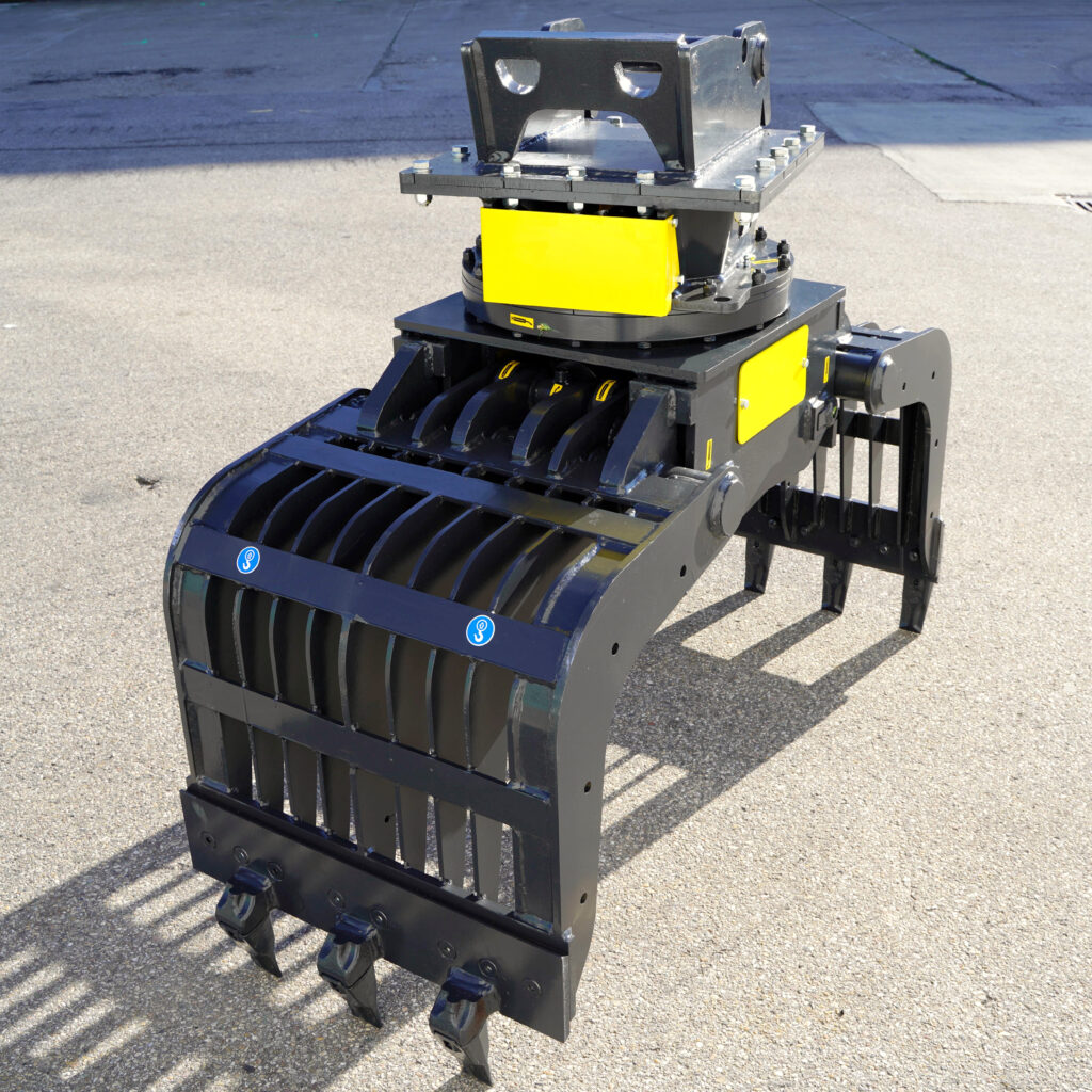 Robuster Sortiergreifer PG450-1 in Schwarz mit gelben Abdeckungen und mehreren Zähnen steht auf Asphalt im Sonnenlicht bei NB Baumaschinen.
